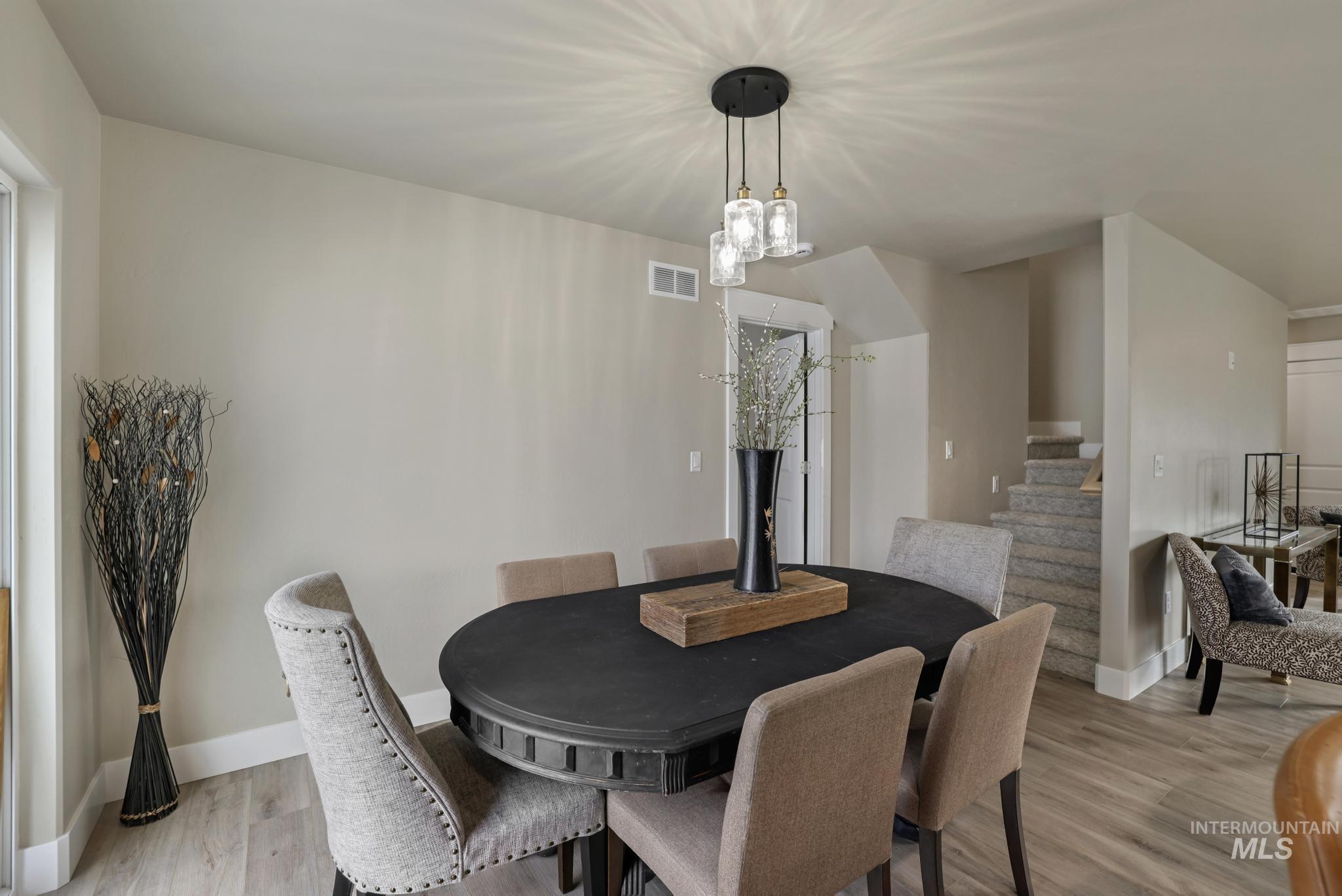 Dining space featuring stairway and light wood-style floors