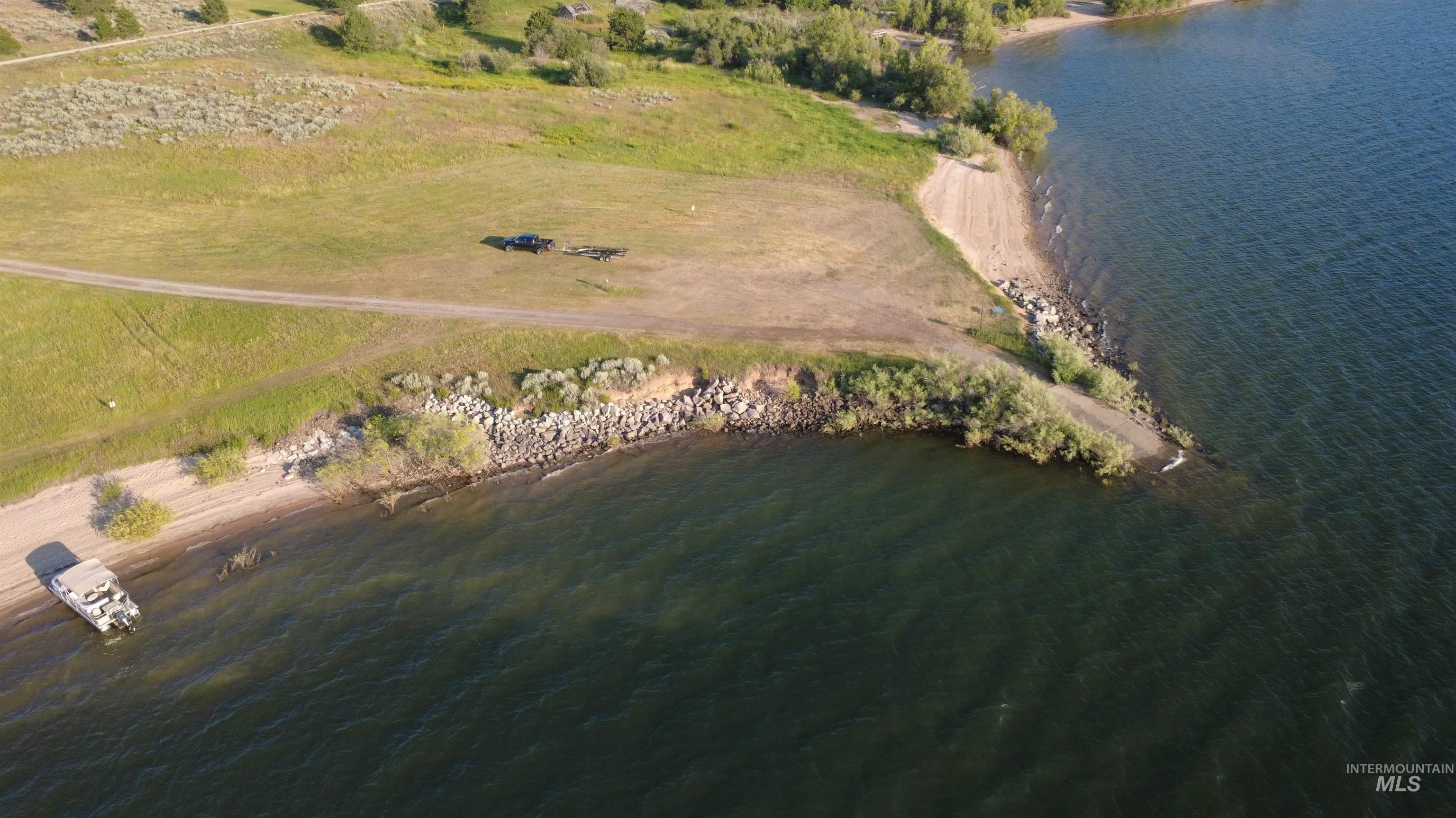 Aerial view of property and surrounding area featuring a large body of water