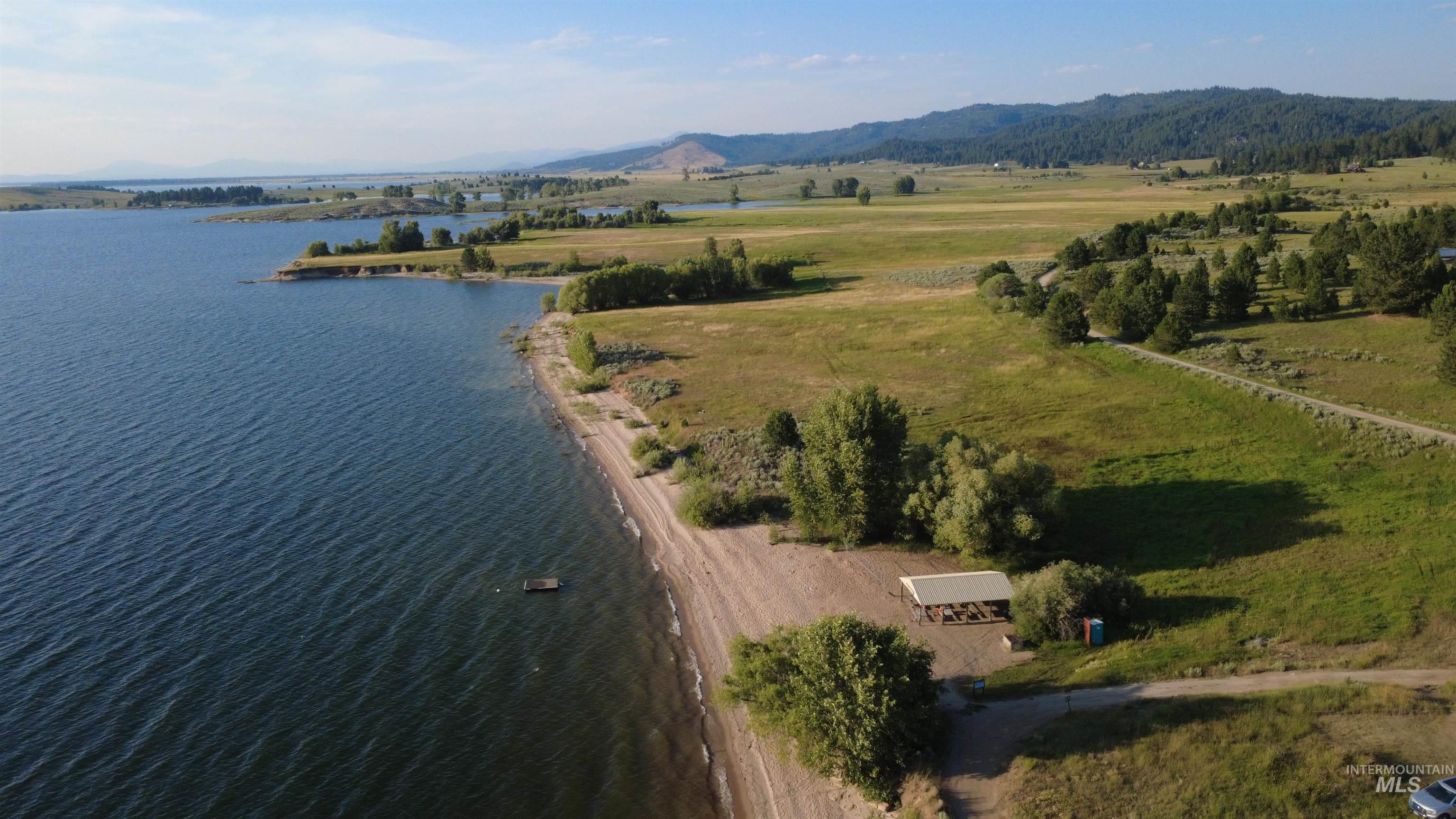 Aerial view of sparsely populated area featuring a water and mountain view