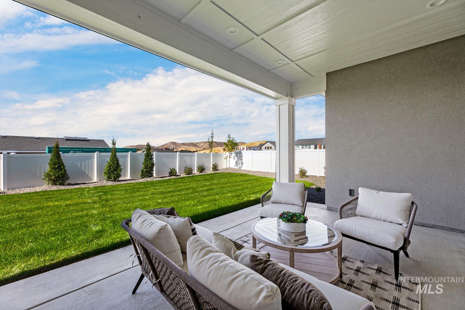 Fenced backyard with outdoor seating and a patio