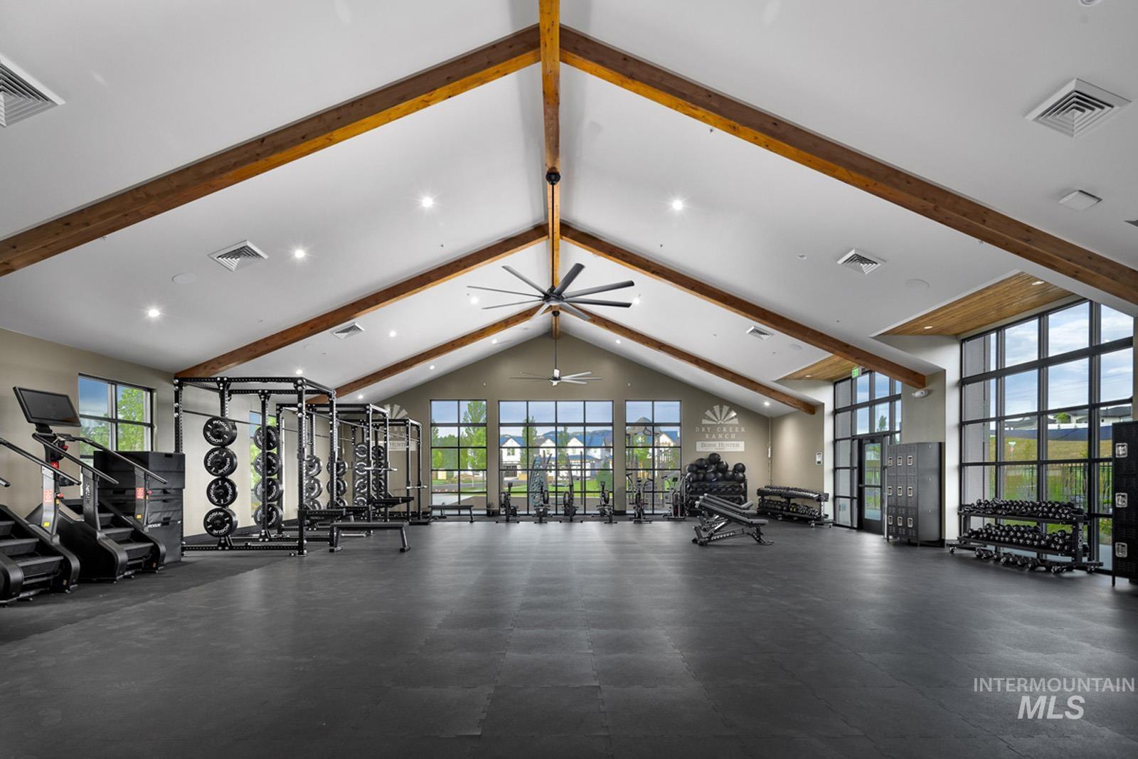 Workout area with a high ceiling and recessed lighting