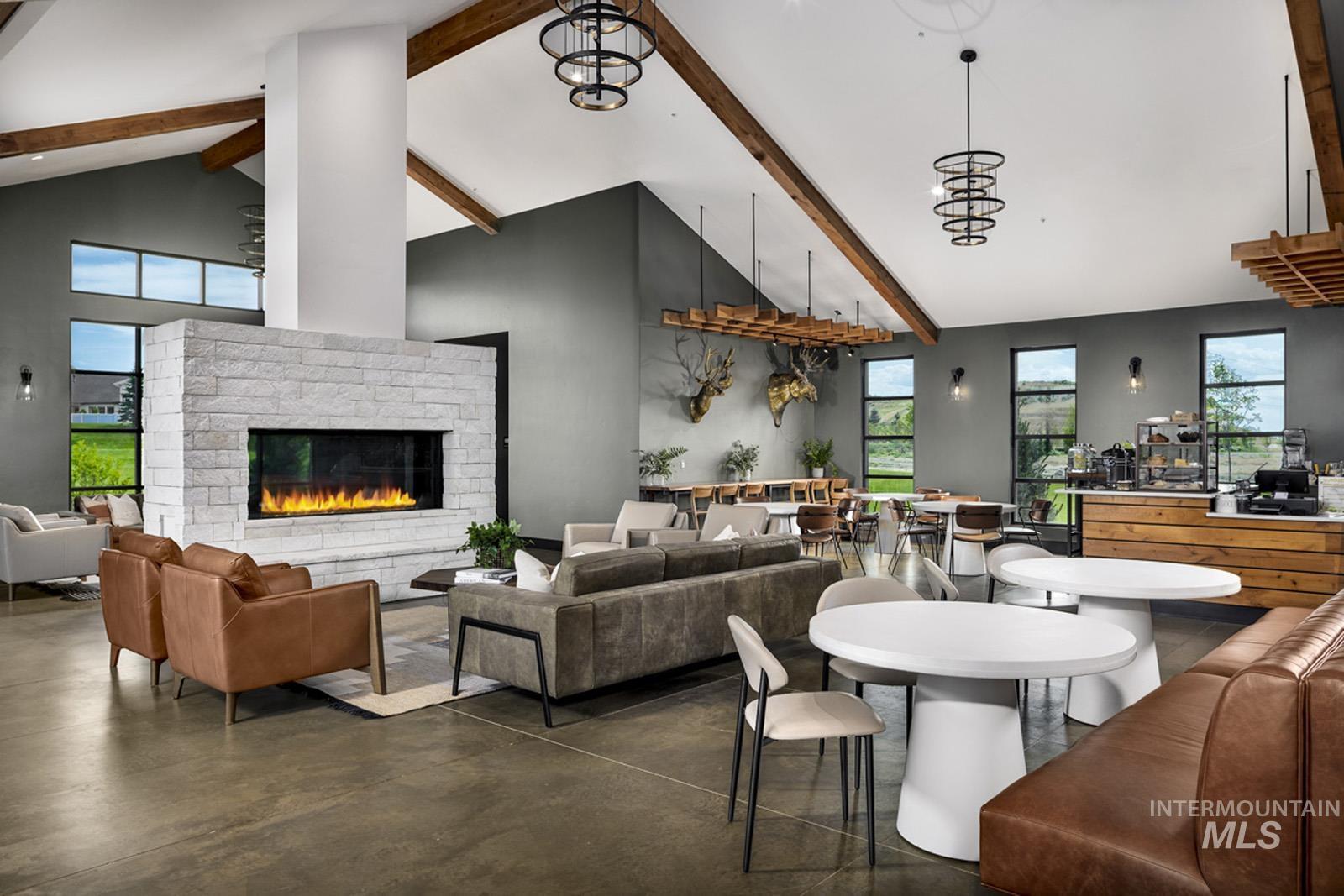 Dining space with finished concrete flooring, a fireplace, and plenty of natural light