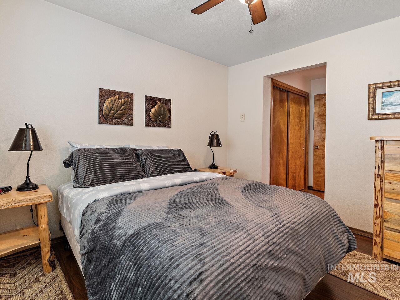 Bedroom with wood finished floors and a ceiling fan