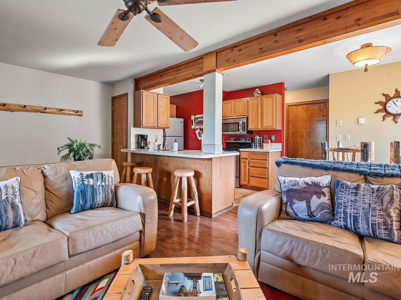 Living area featuring light wood-type flooring and a ceiling fan