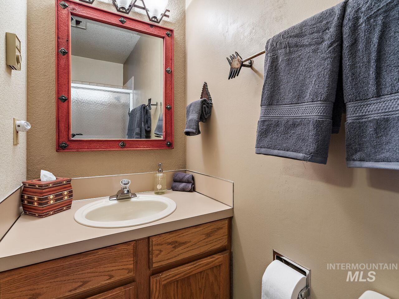 Bathroom featuring vanity and a shower with shower door