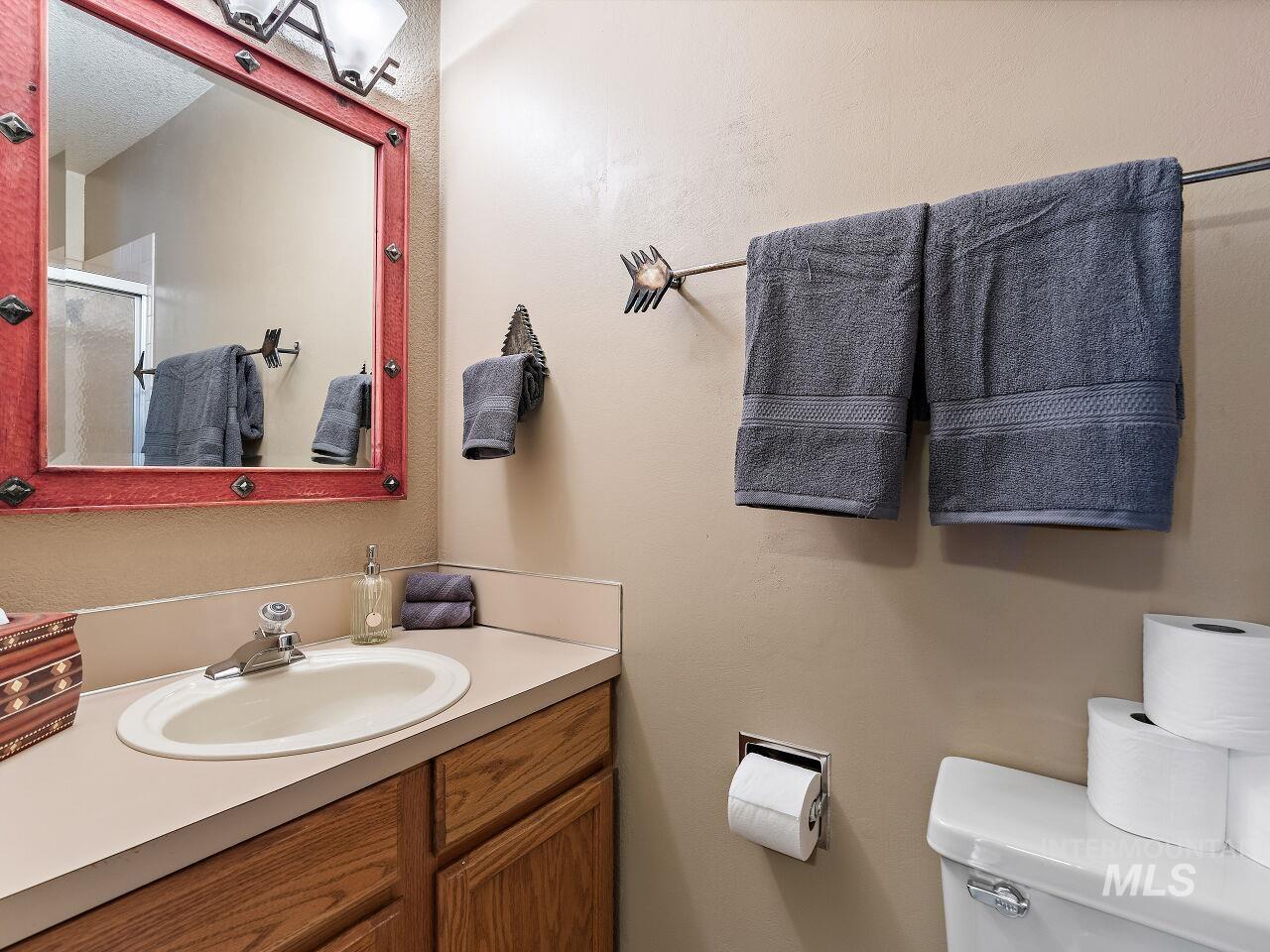Full bathroom with vanity and a stall shower