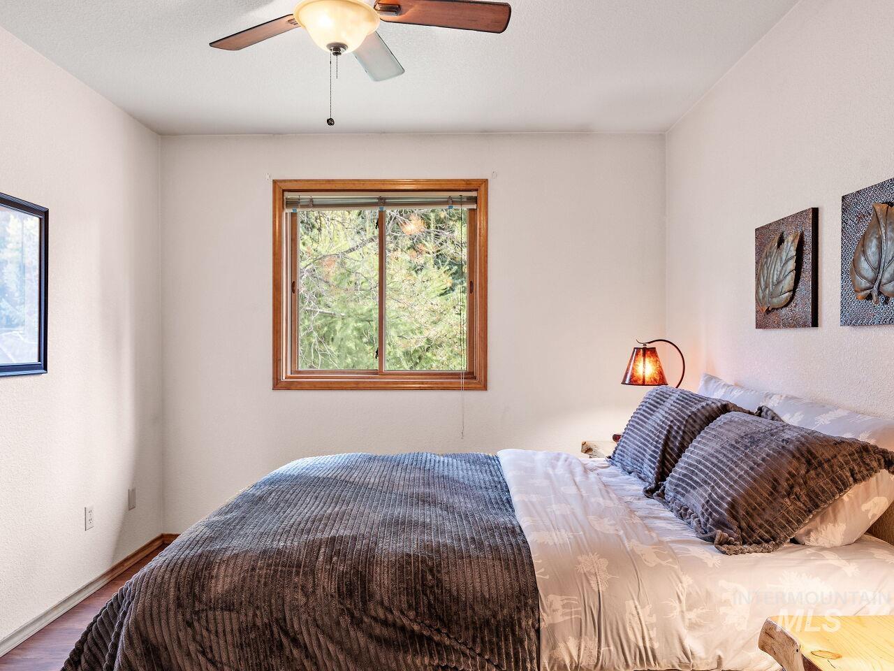Bedroom featuring wood finished floors and ceiling fan