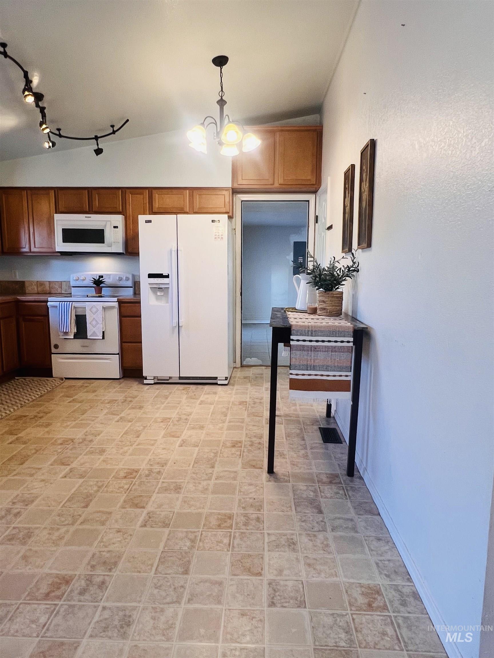 Kitchen featuring wood-finish cabinetry and tile-finish flooring
