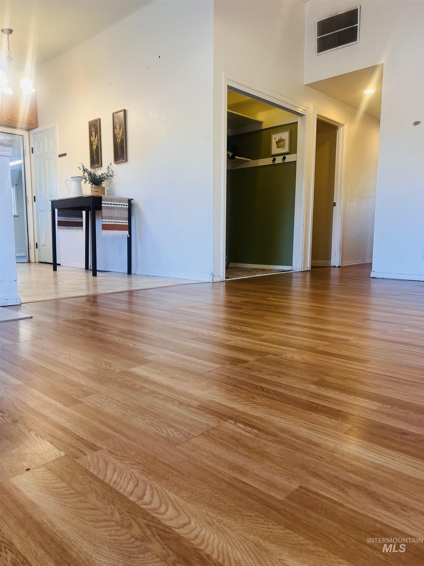 Warm wood-finish flooring extending throughout the space