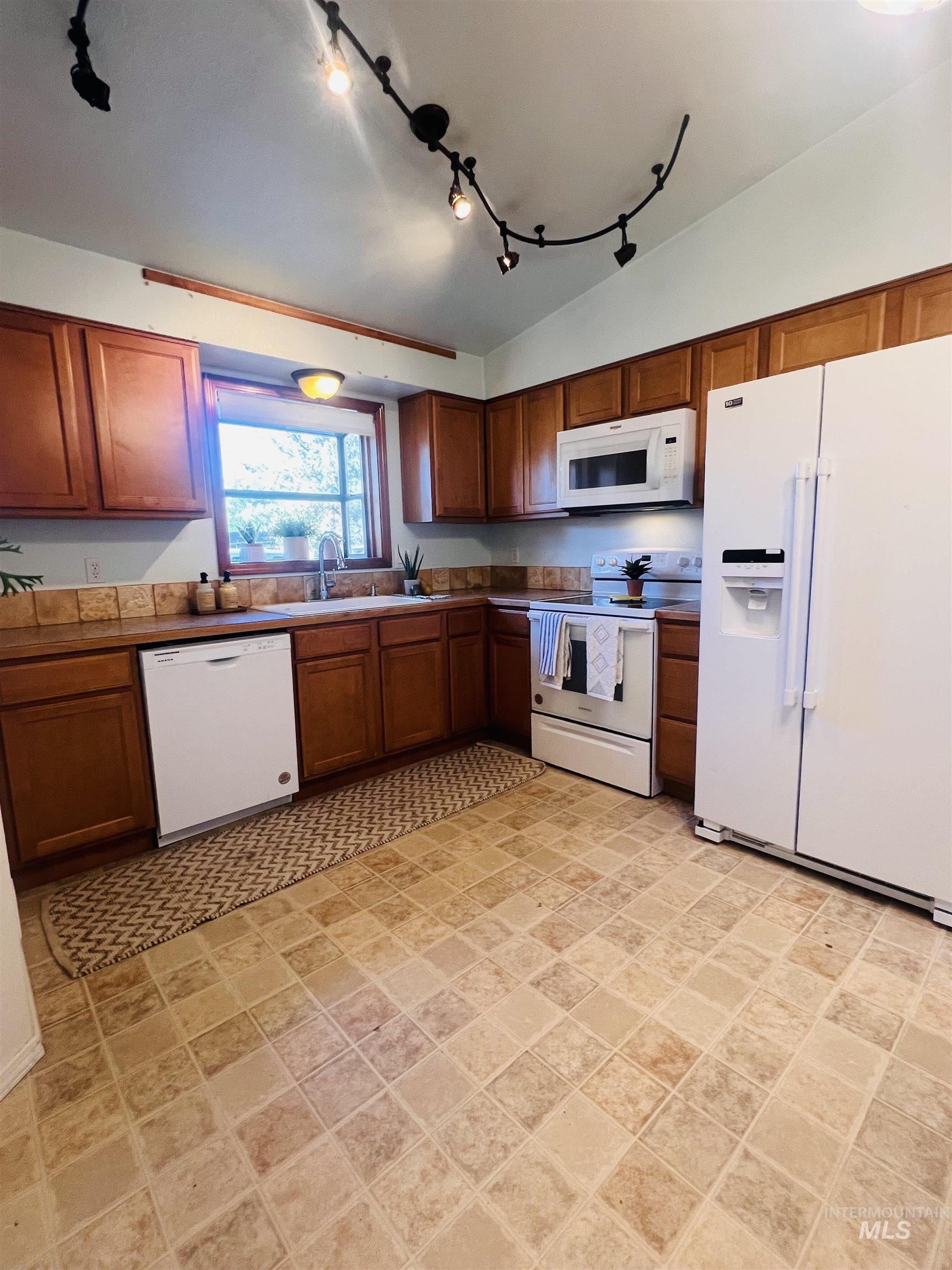 Kitchen with wood-finish cabinetry and a tiled backsplash
