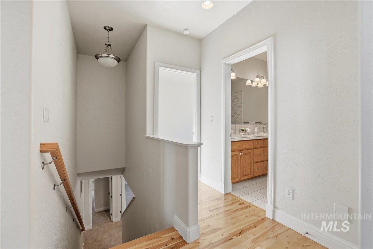 Stairs featuring wood finished floors and baseboards