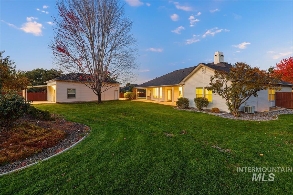 Rear view of house with a patio area and a chimney