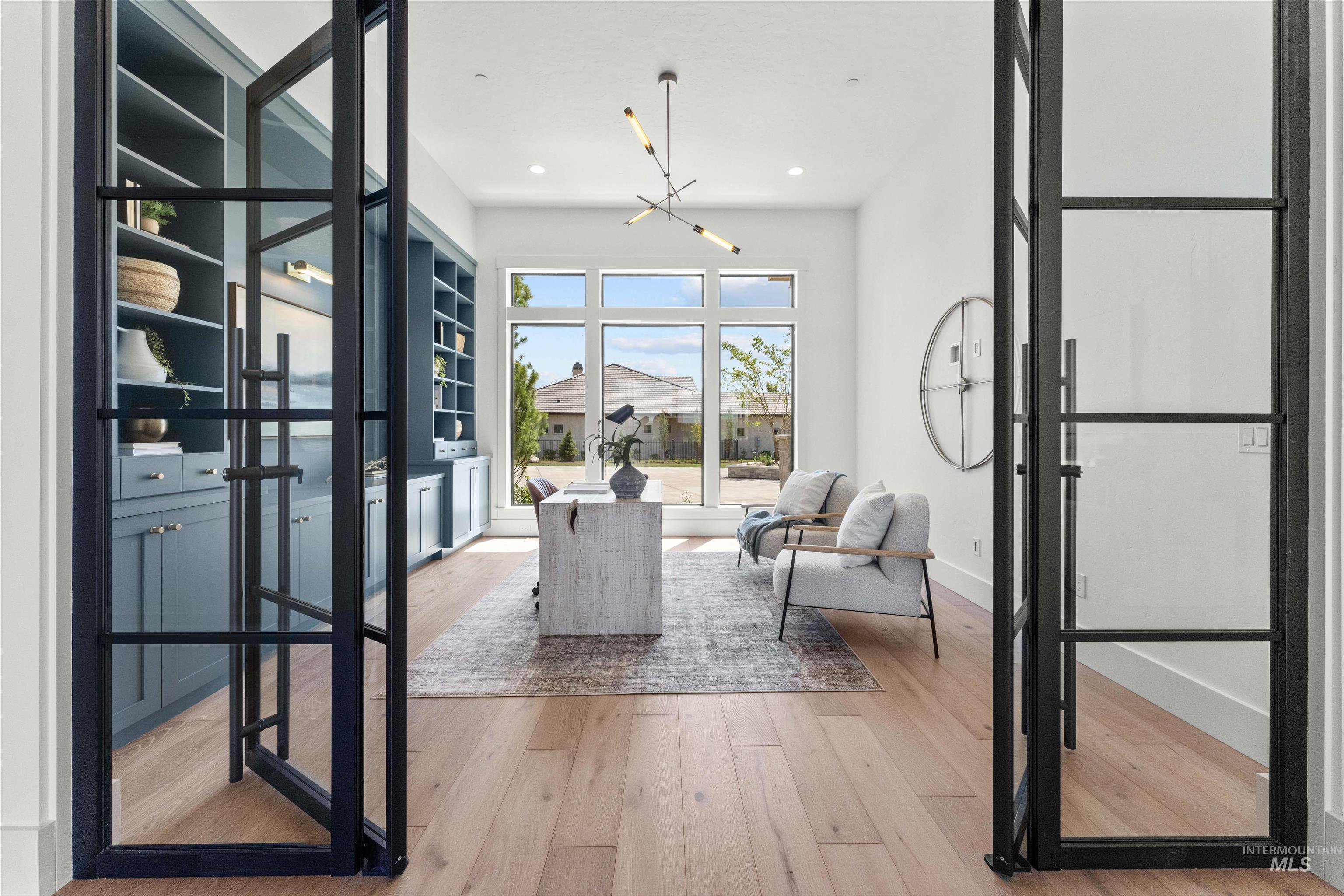 Living area with wood-type flooring, a chandelier, and recessed lighting