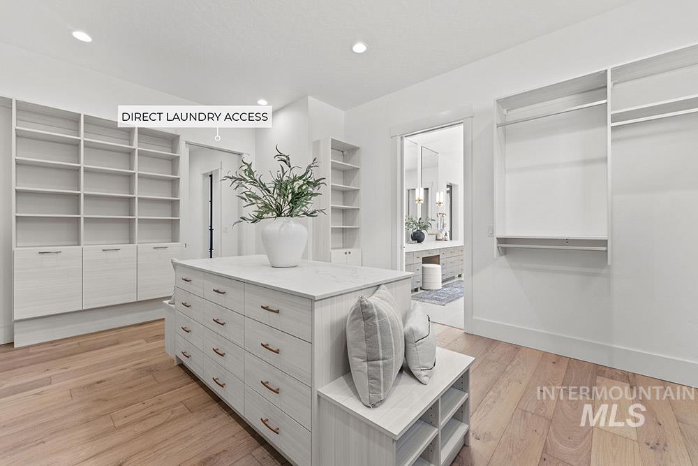 Spacious closet featuring light wood-style flooring