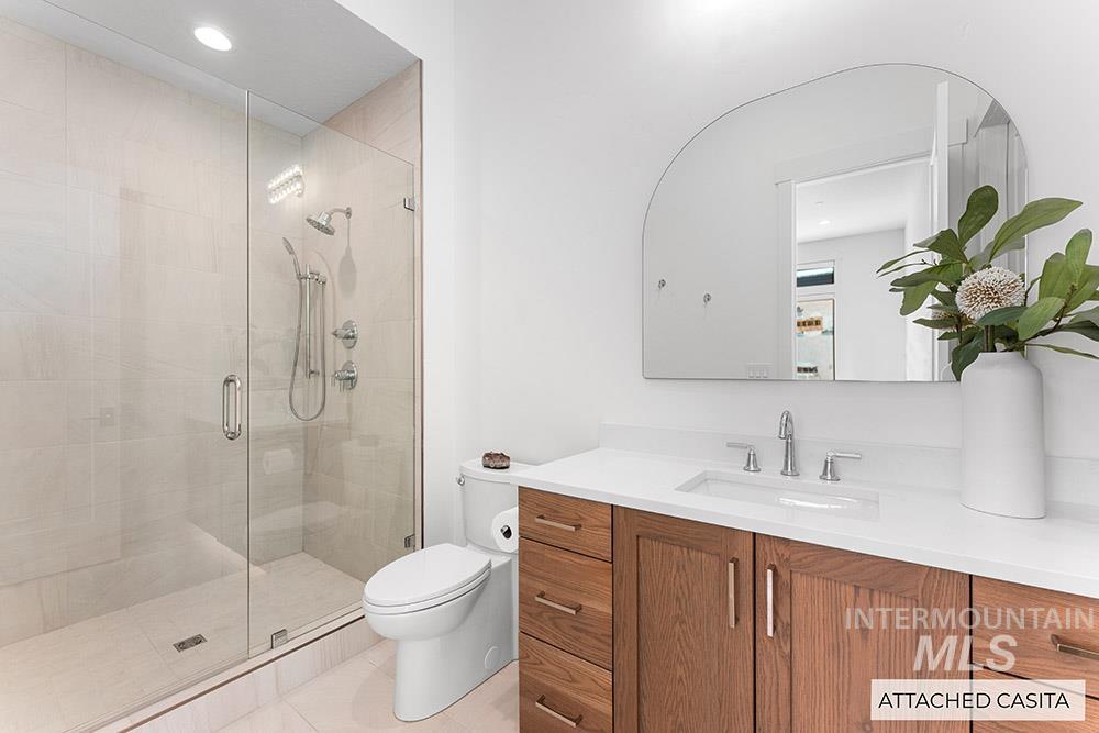 Bathroom with vanity, a stall shower, and recessed lighting