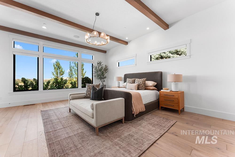 Bedroom featuring beam ceiling, light wood-style flooring, a chandelier, and recessed lighting