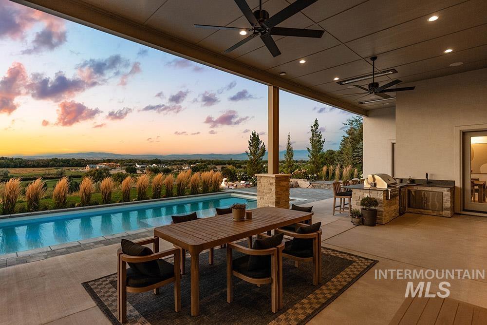Swimming pool featuring area for grilling, a ceiling fan, a patio area, and outdoor dining area