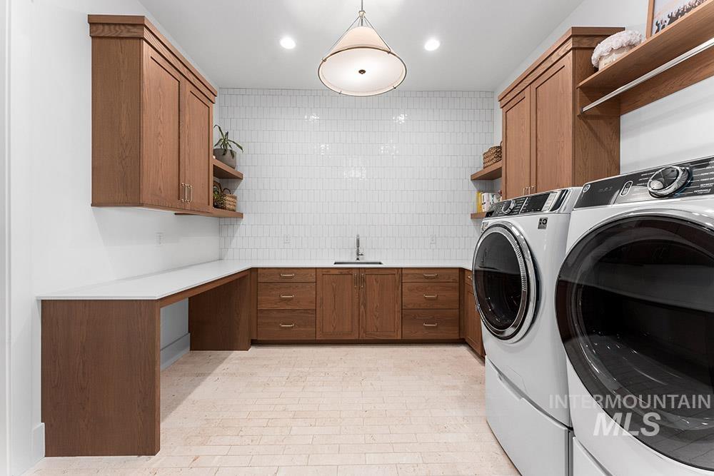 Laundry room with washing machine and clothes dryer and cabinet space