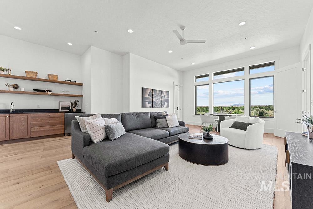 Living area featuring light wood-type flooring, recessed lighting, and a ceiling fan