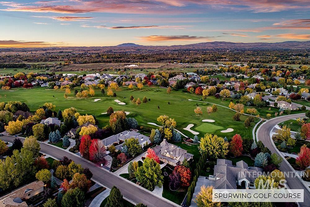 Aerial view at dusk of golf course view, a residential view, and a mountain view
