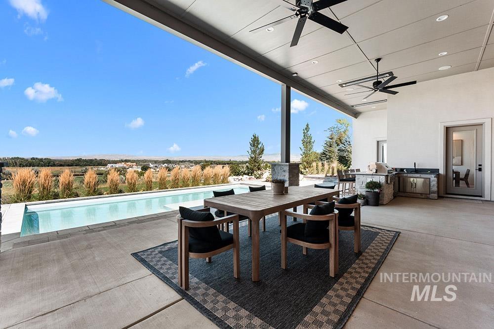 View of patio / terrace featuring area for grilling, a ceiling fan, an outdoor pool, and outdoor dining area