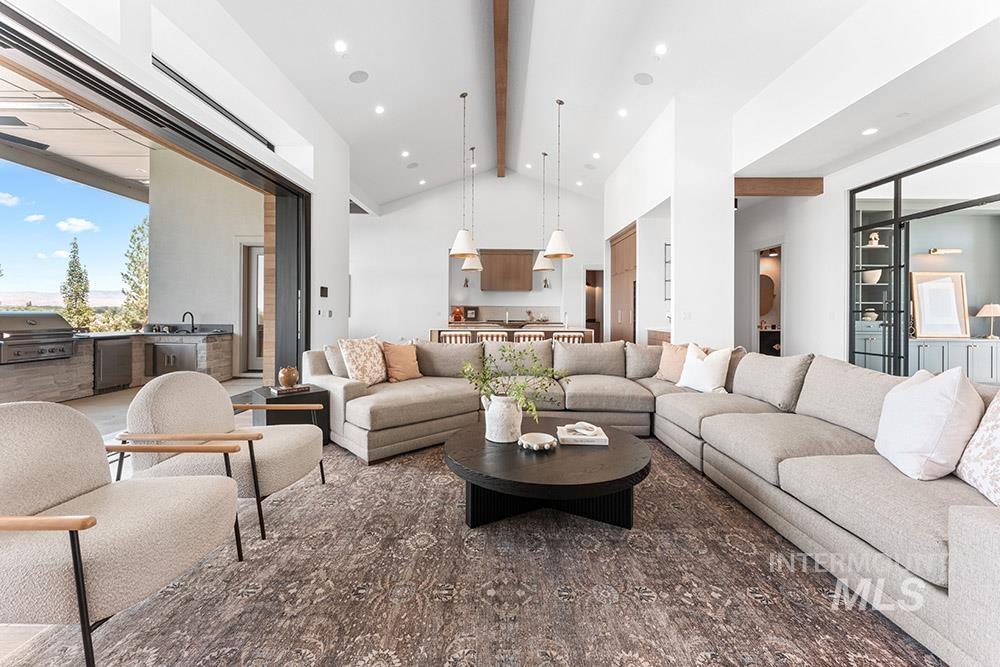 Living room featuring beamed ceiling, high vaulted ceiling, and recessed lighting