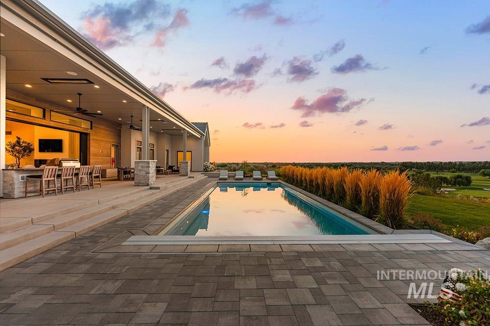 Outdoor pool featuring a patio and ceiling fan