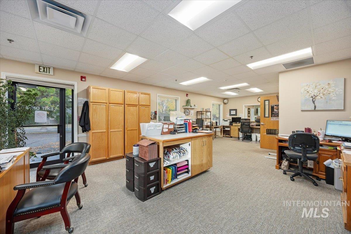 Office featuring healthy amount of natural light and a drop ceiling