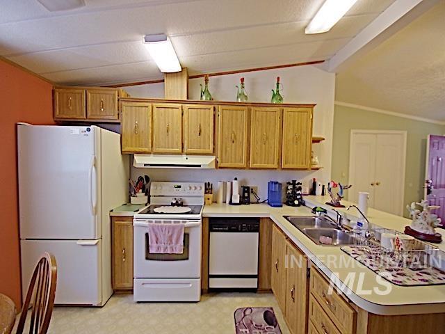 Kitchen with wood-finish cabinetry, laminate countertops, and double basin sink