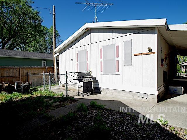 White-sided exterior with red-trimmed window shutters