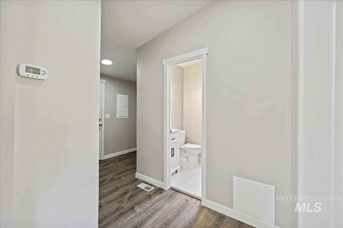 Corridor with wood finished floors and baseboards