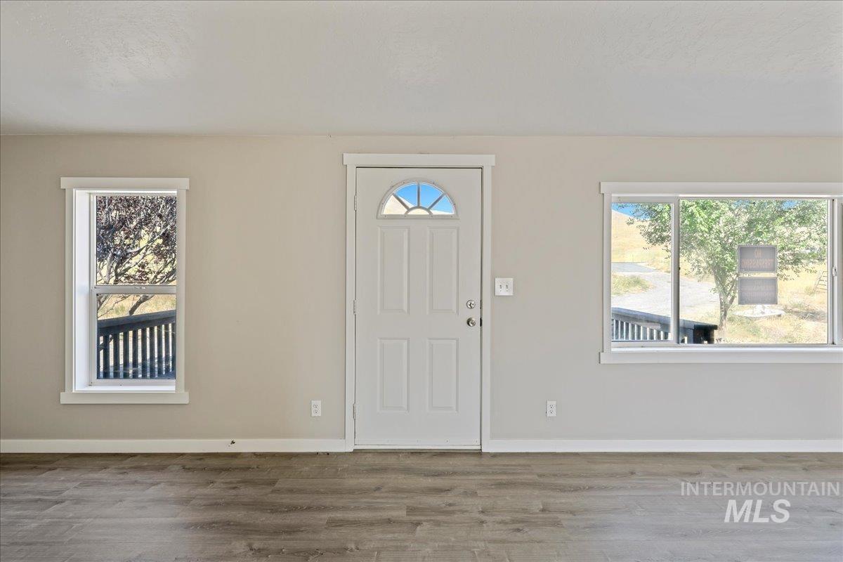 Entryway with wood finished floors and baseboards