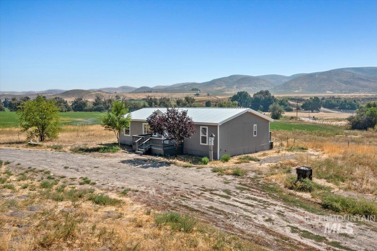 View of mountain backdrop featuring rural landscape