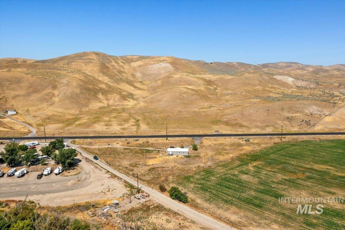 Aerial view of property's location with a mountainous background and rural landscape