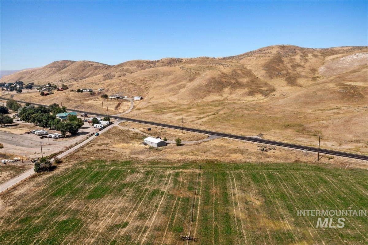 Aerial overview of property's location with rural landscape and a mountain backdrop