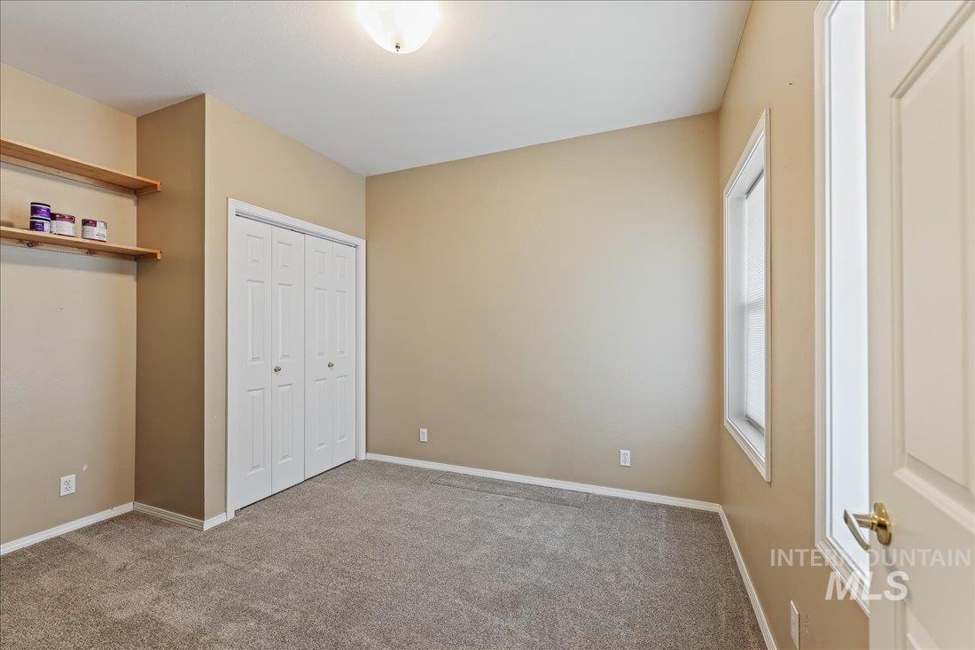 Unfurnished bedroom featuring carpet and a closet