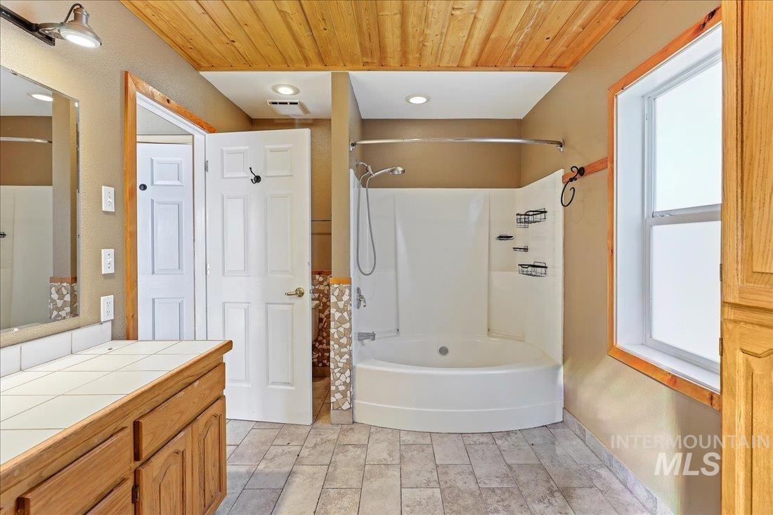 Full bath featuring shower / washtub combination, wood ceiling, vanity, and recessed lighting