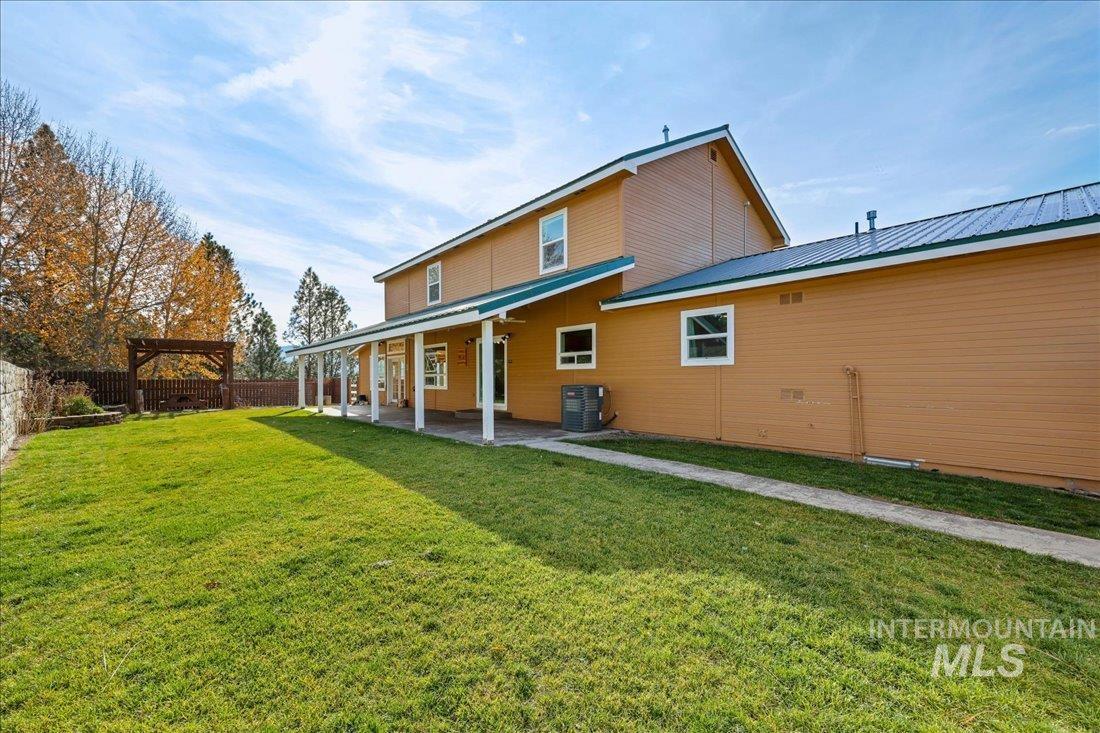 Rear view of property with a patio and a metal roof