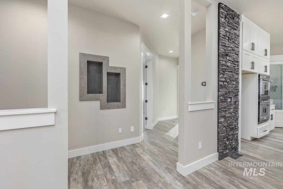 Hallway with baseboards and light wood-style flooring