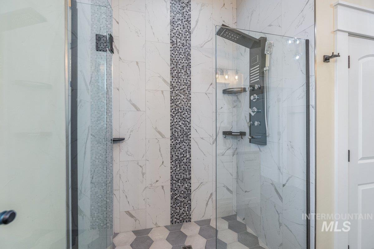 Bathroom featuring a marble finish shower