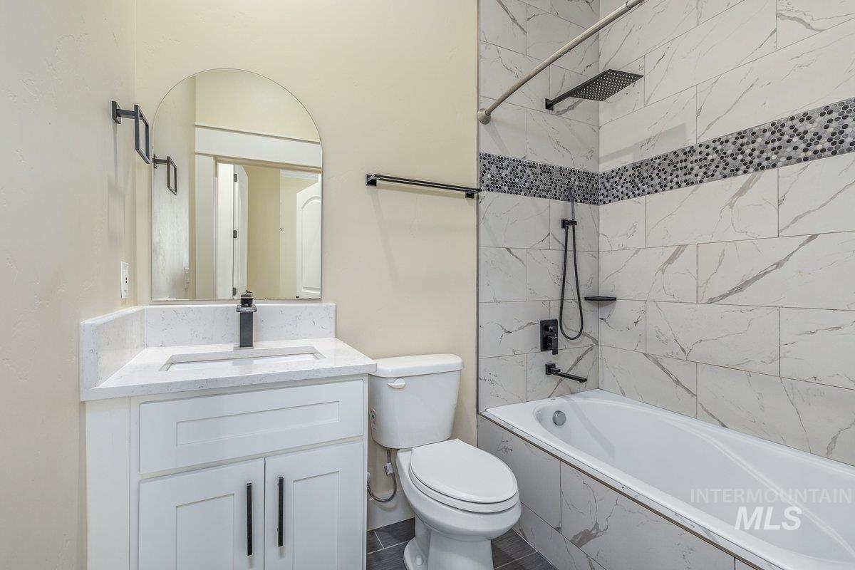 Full bath featuring vanity and shower / washtub combination