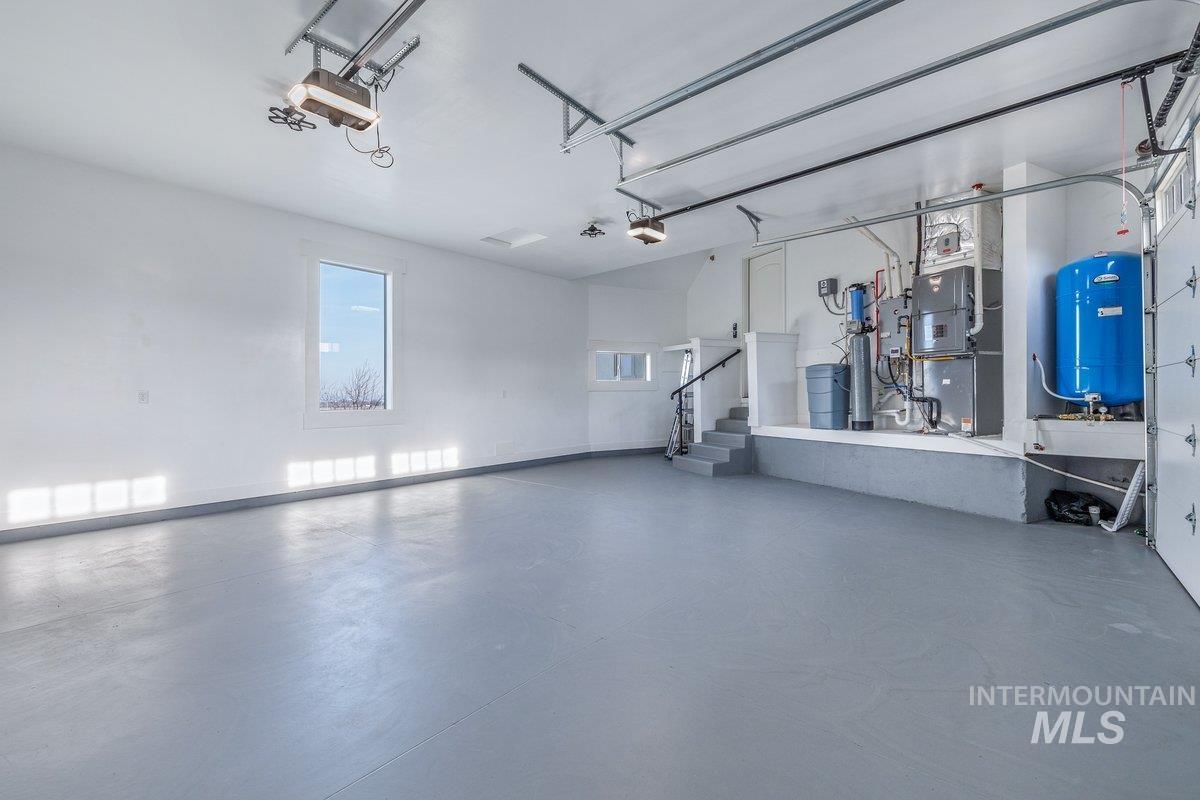 Garage featuring heating unit and a garage door opener