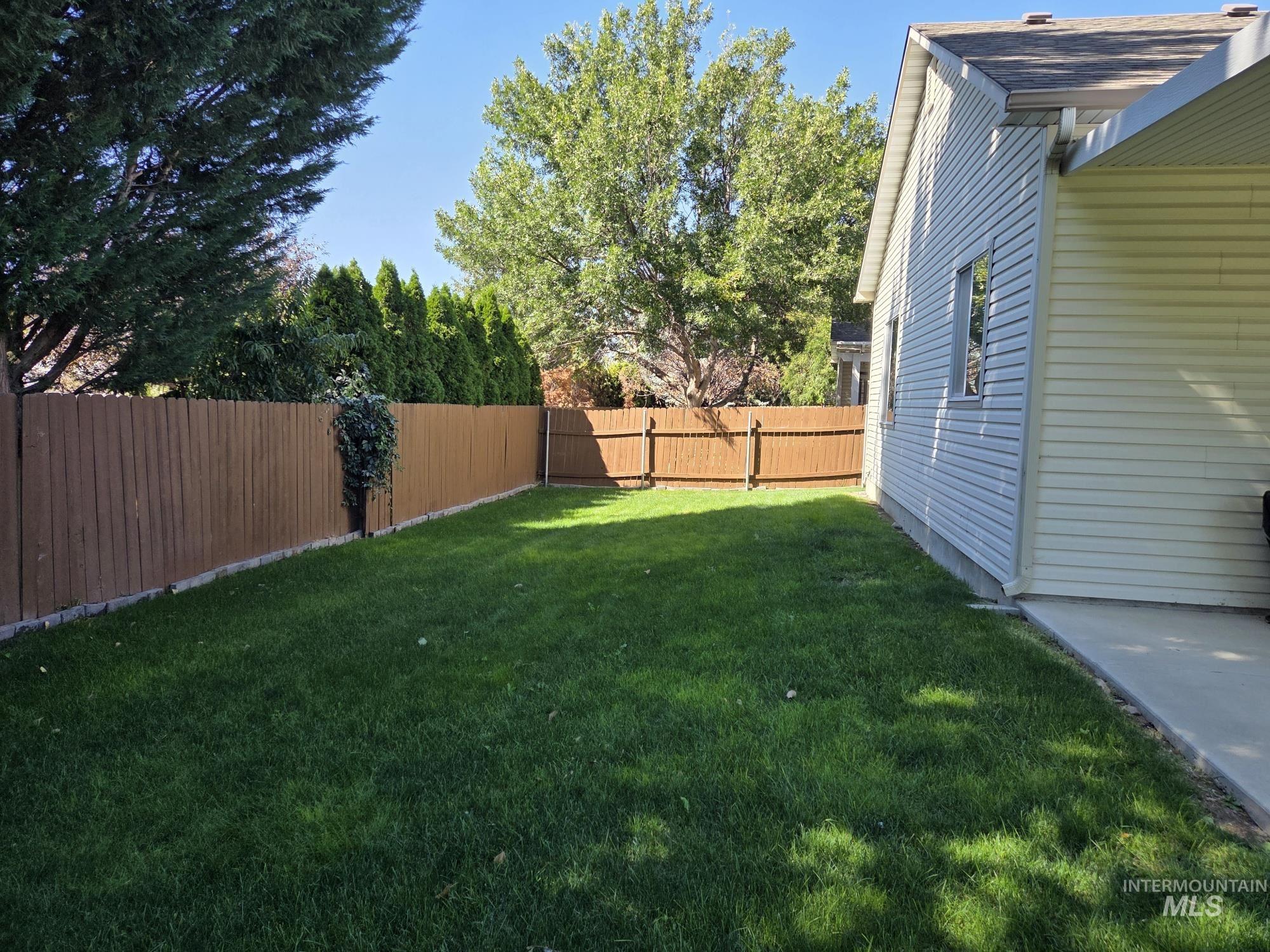 View of fenced backyard