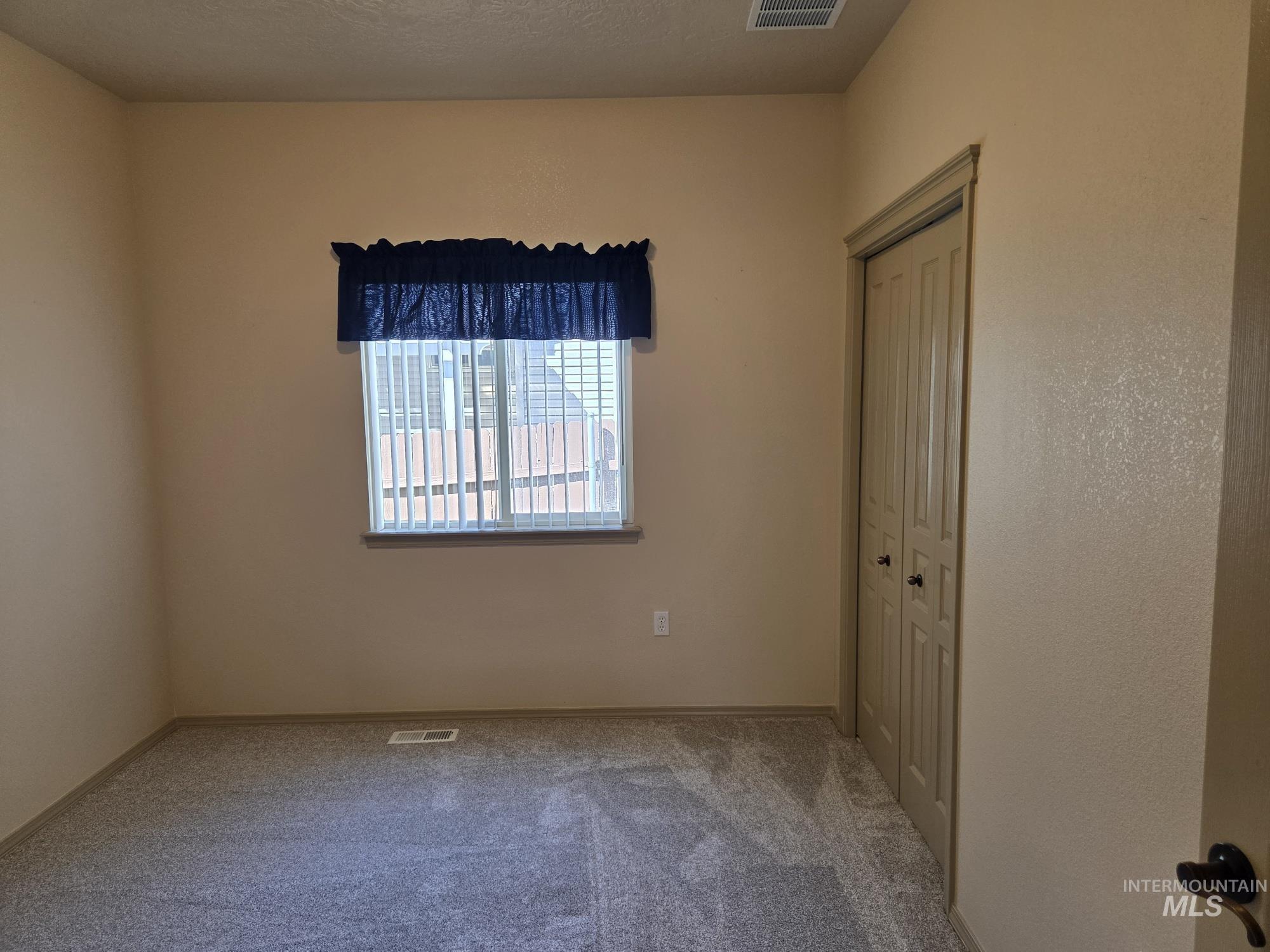 Unfurnished bedroom featuring carpet floors and a closet
