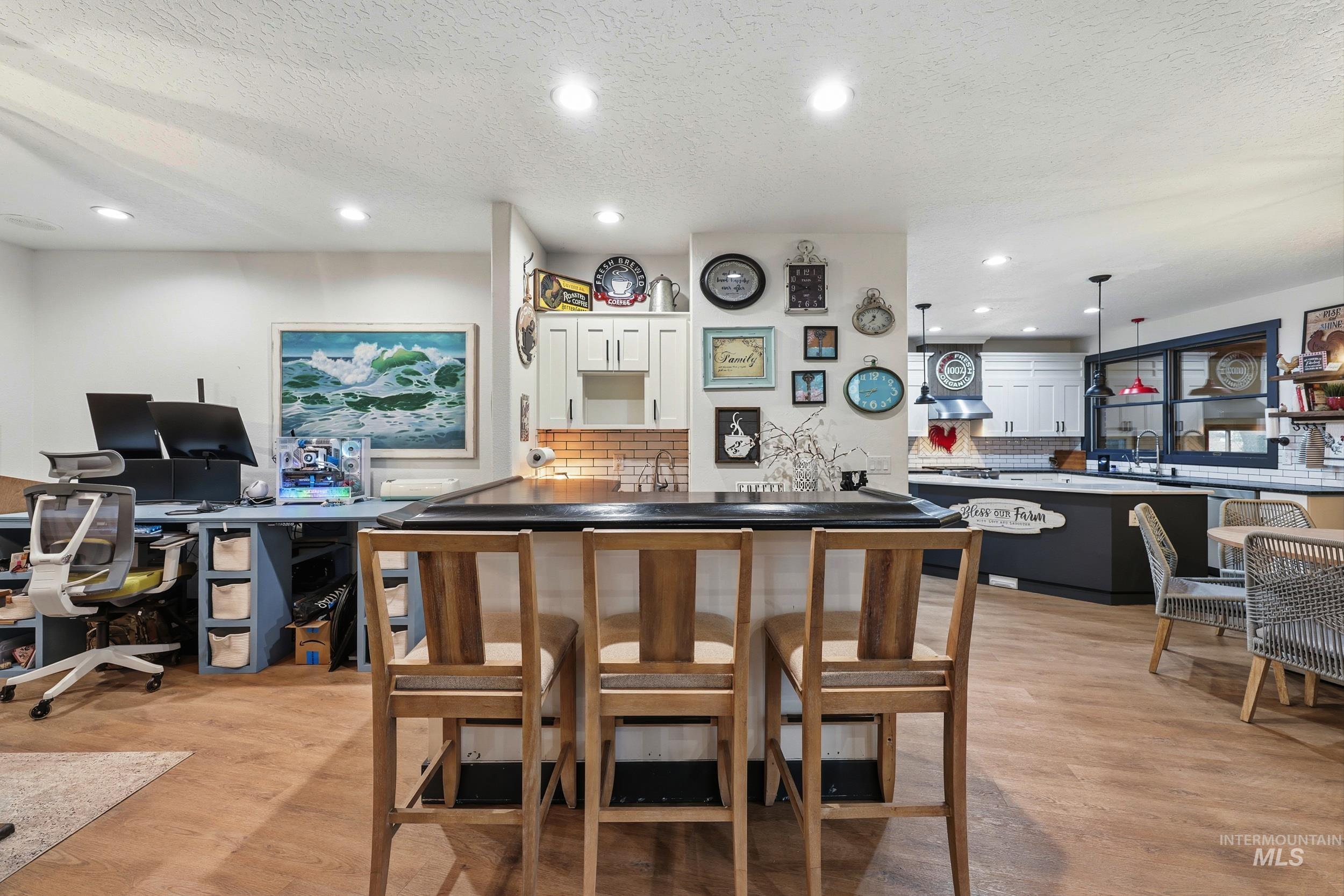 Bar featuring a textured ceiling, white cabinets, hanging light fixtures, open shelves, and recessed lighting