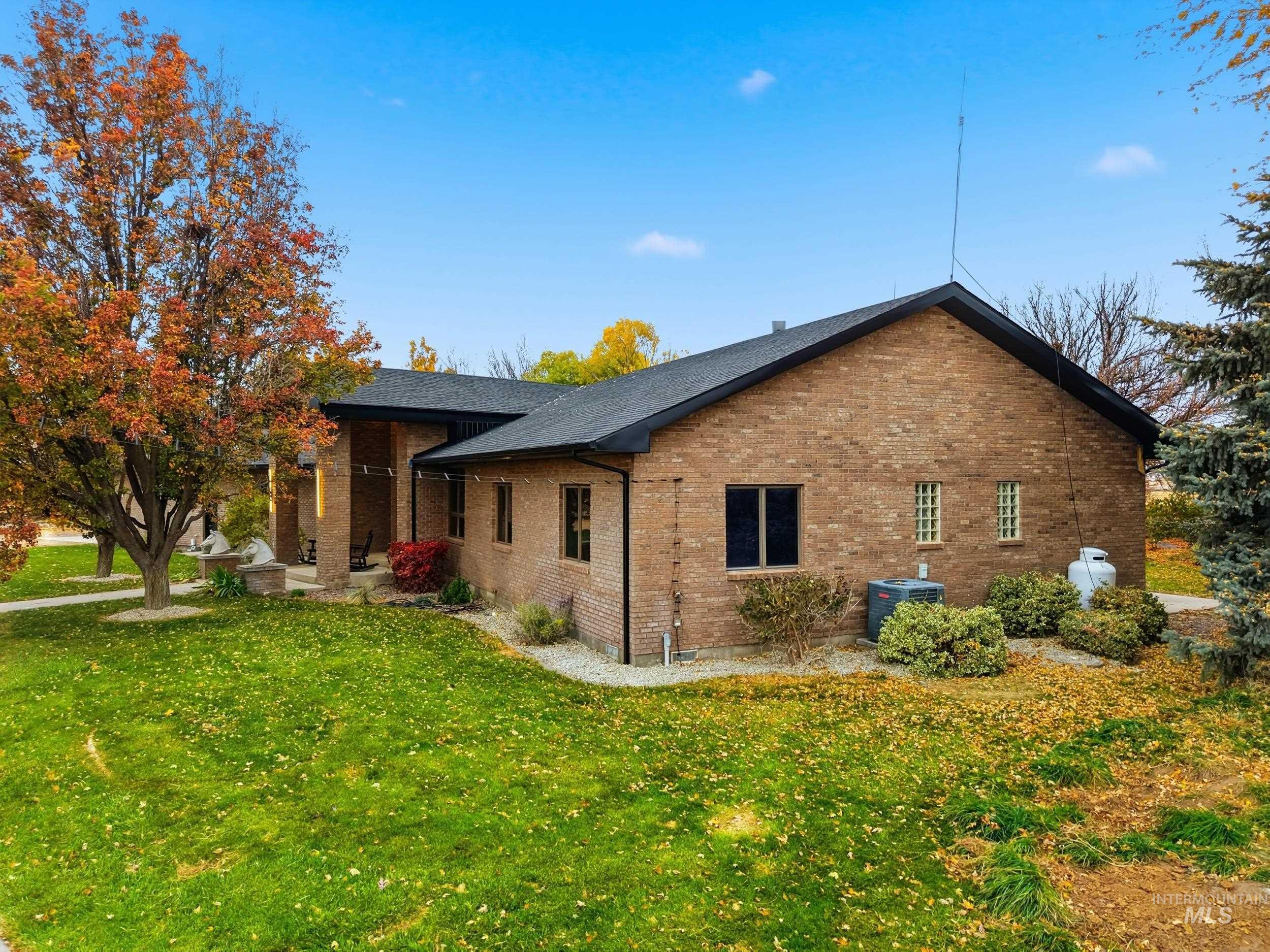 View of property exterior featuring a yard and brick siding