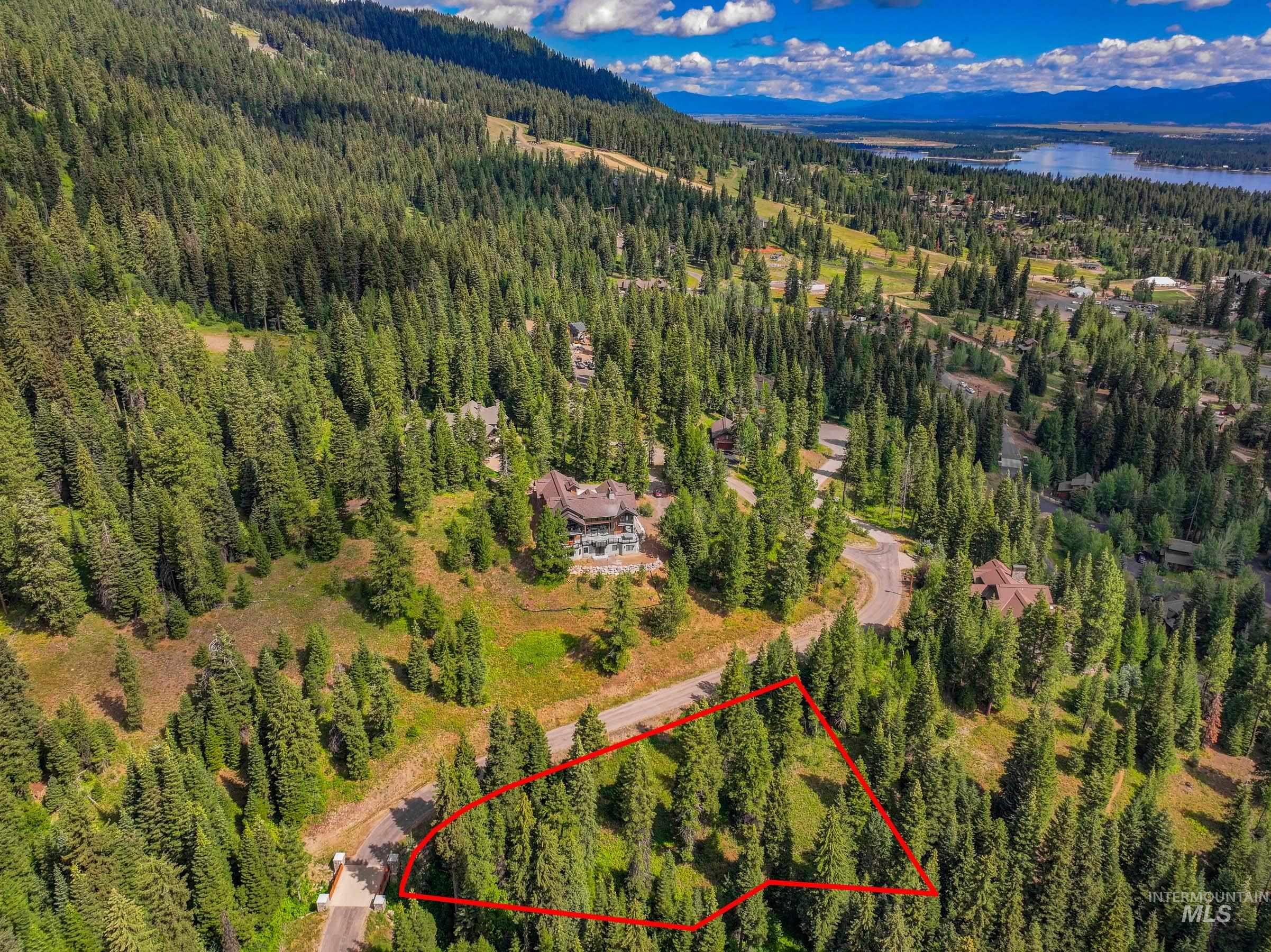 Aerial view of property's location featuring property parcel outlined and a mountainous background