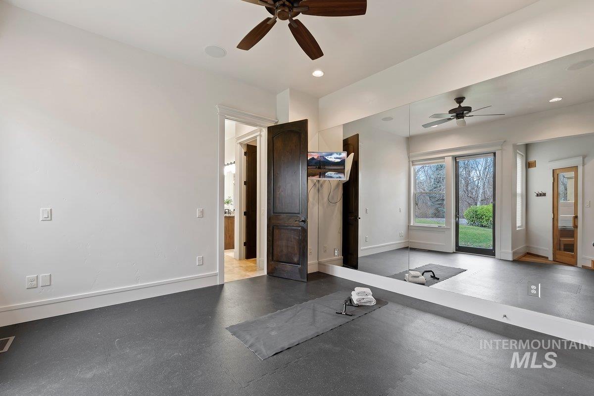 Workout area with rubber floors, recessed lighting, and ceiling fan