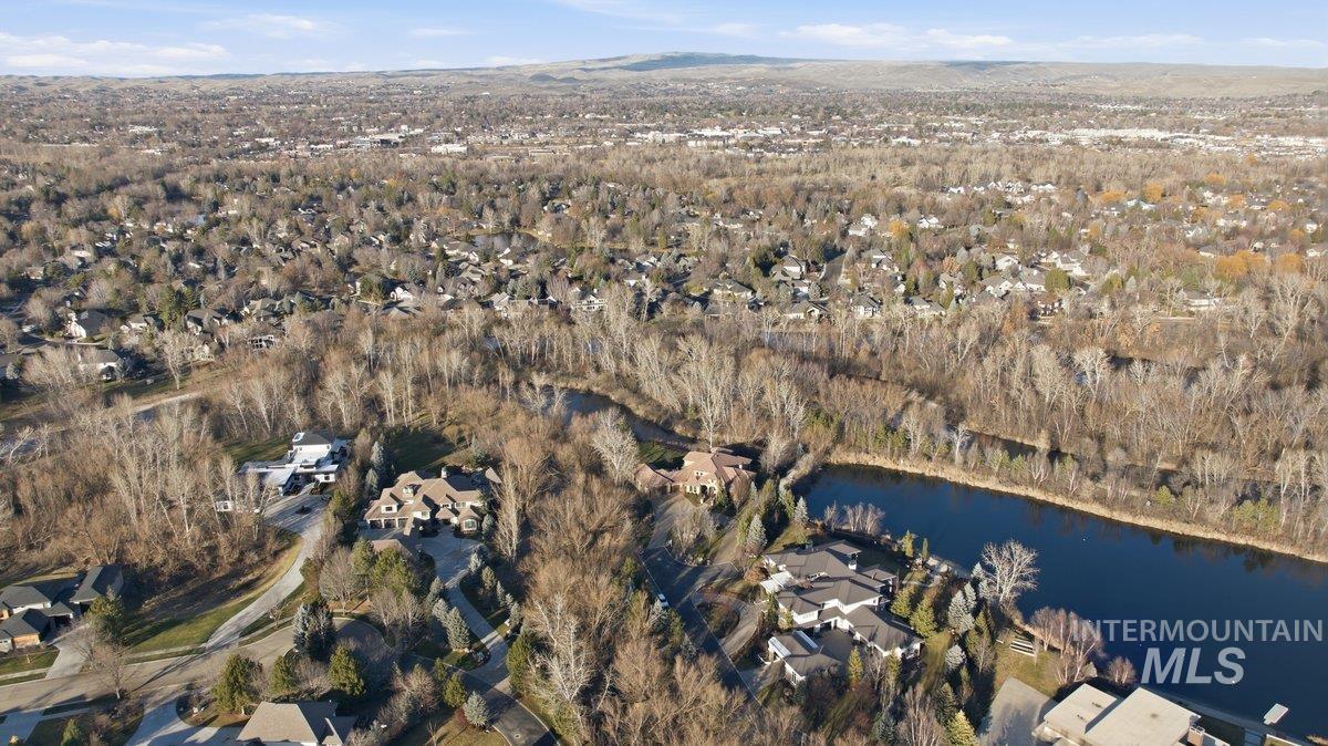 Aerial view of property's location with nearby suburban area and a mountainous background