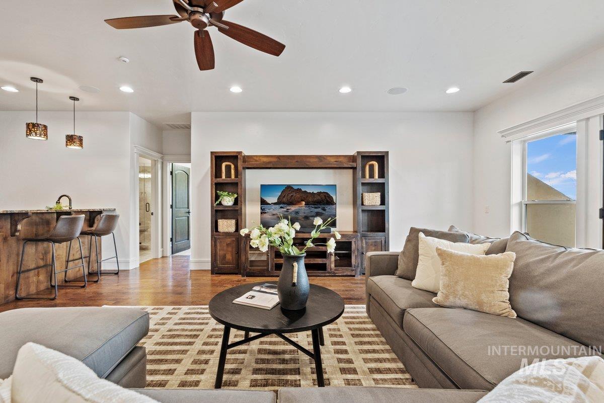 Living room featuring wood finished floors, a ceiling fan, and recessed lighting